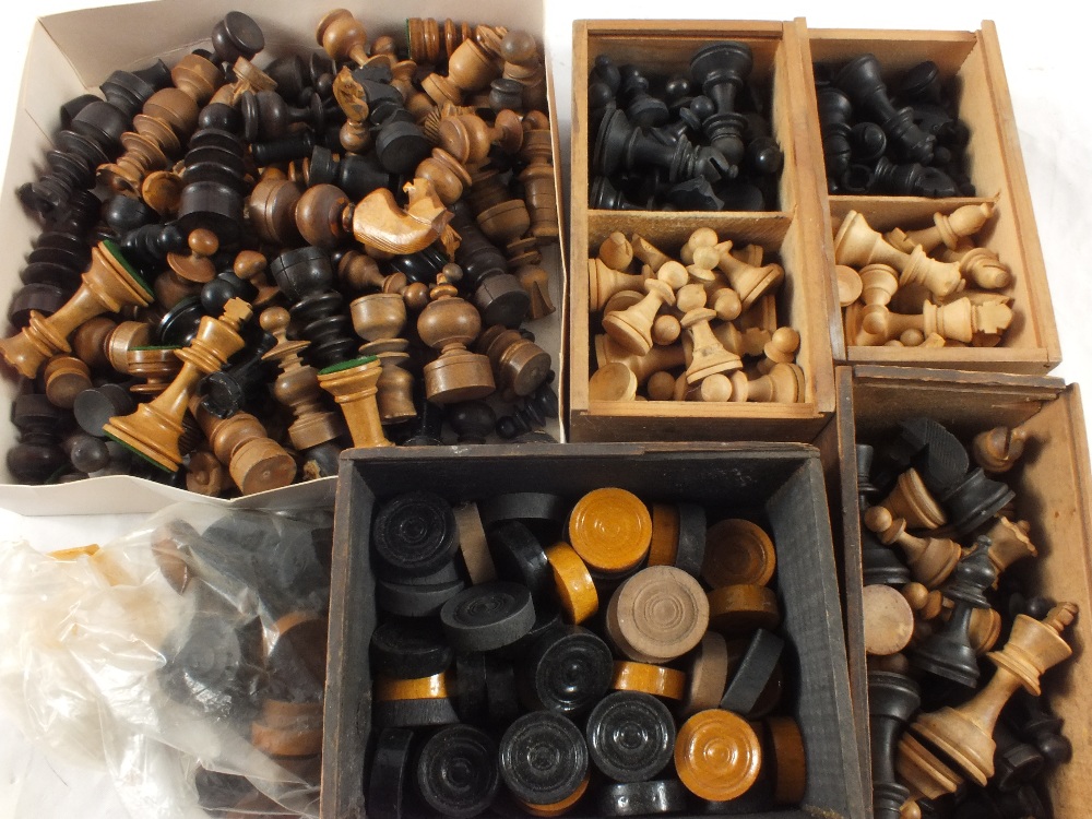 Various wooden chess pieces and draughts
