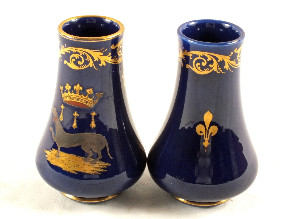 A pair of 20th Century French blue ground vases with coronet and family armorial, height 4 1/2"