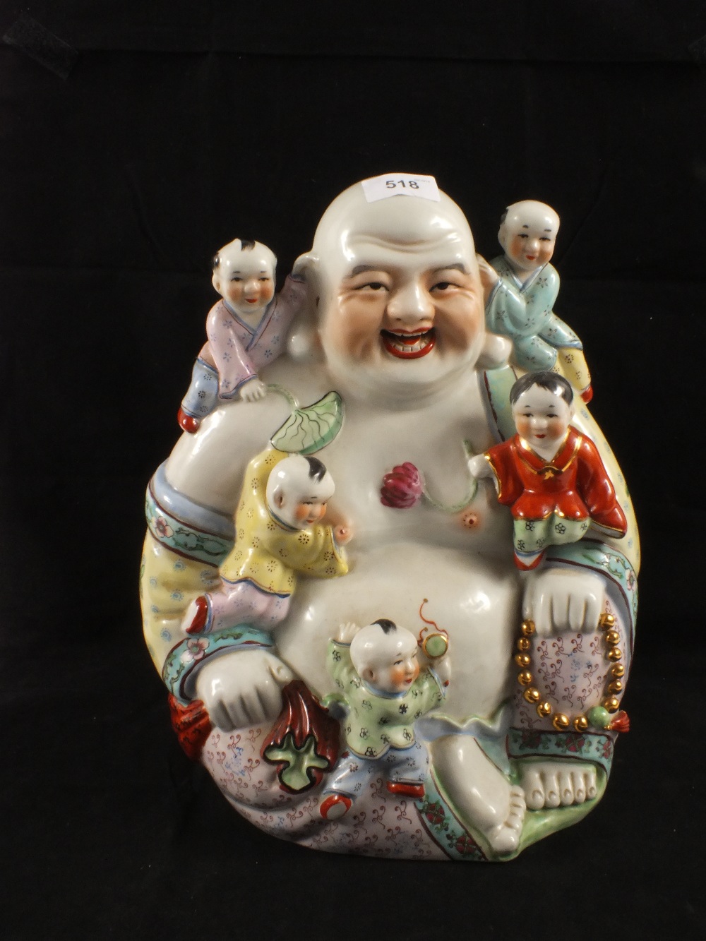 A Chinese porcelain Buddha sprouting children
