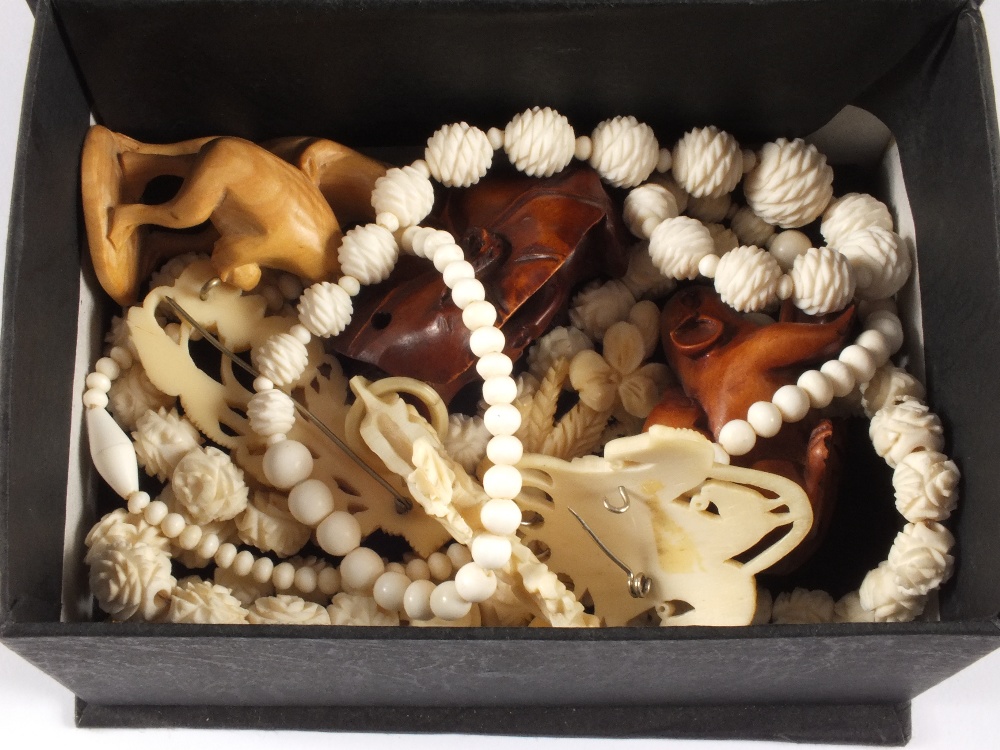 Various Ivory brooches and beads and three wood animal netsuke`s