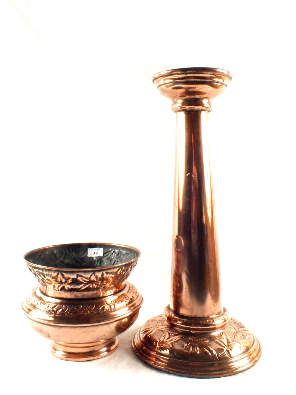 An Arts and Crafts Copper jardinière and stand with embossed floral decoration, height 31"