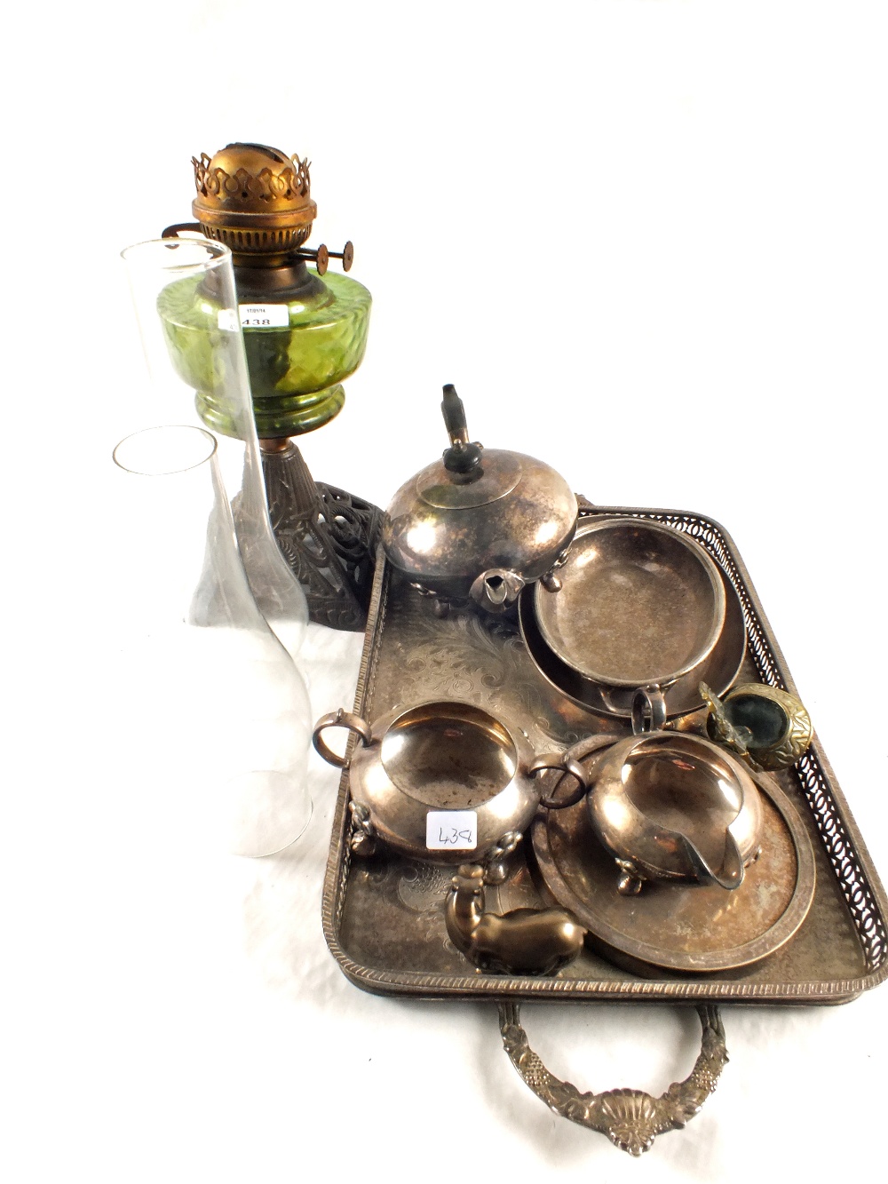 An iron base green glass oil lamp and various silver plated wares