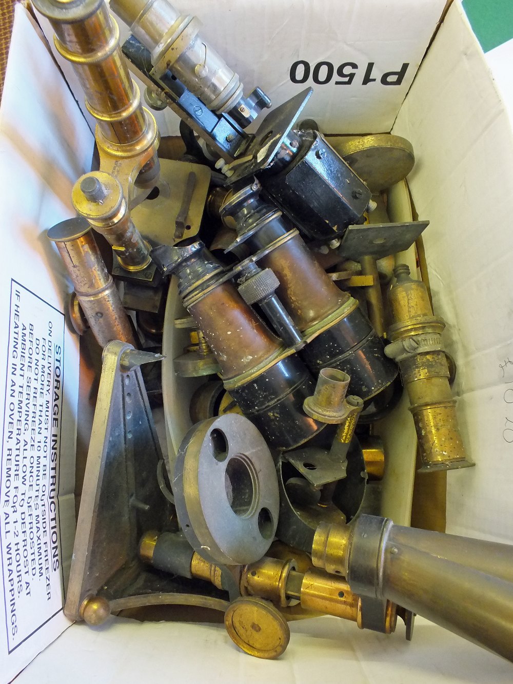 A box of Victorian microscopes and optical parts