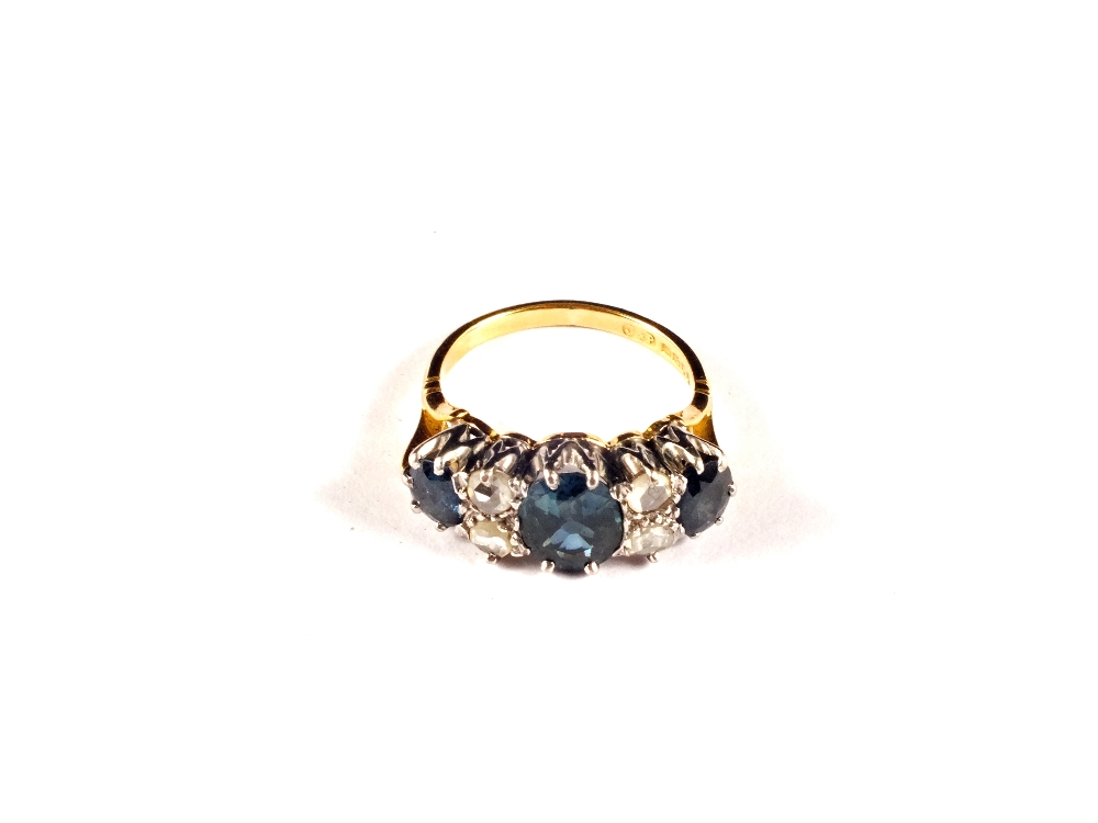 An 18ct Gold ring set with three blue Topaz and four white Topaz, size N