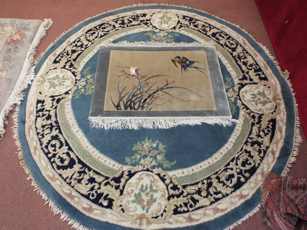 A circular Indian floral carpet and a Chinese bird decorated rug