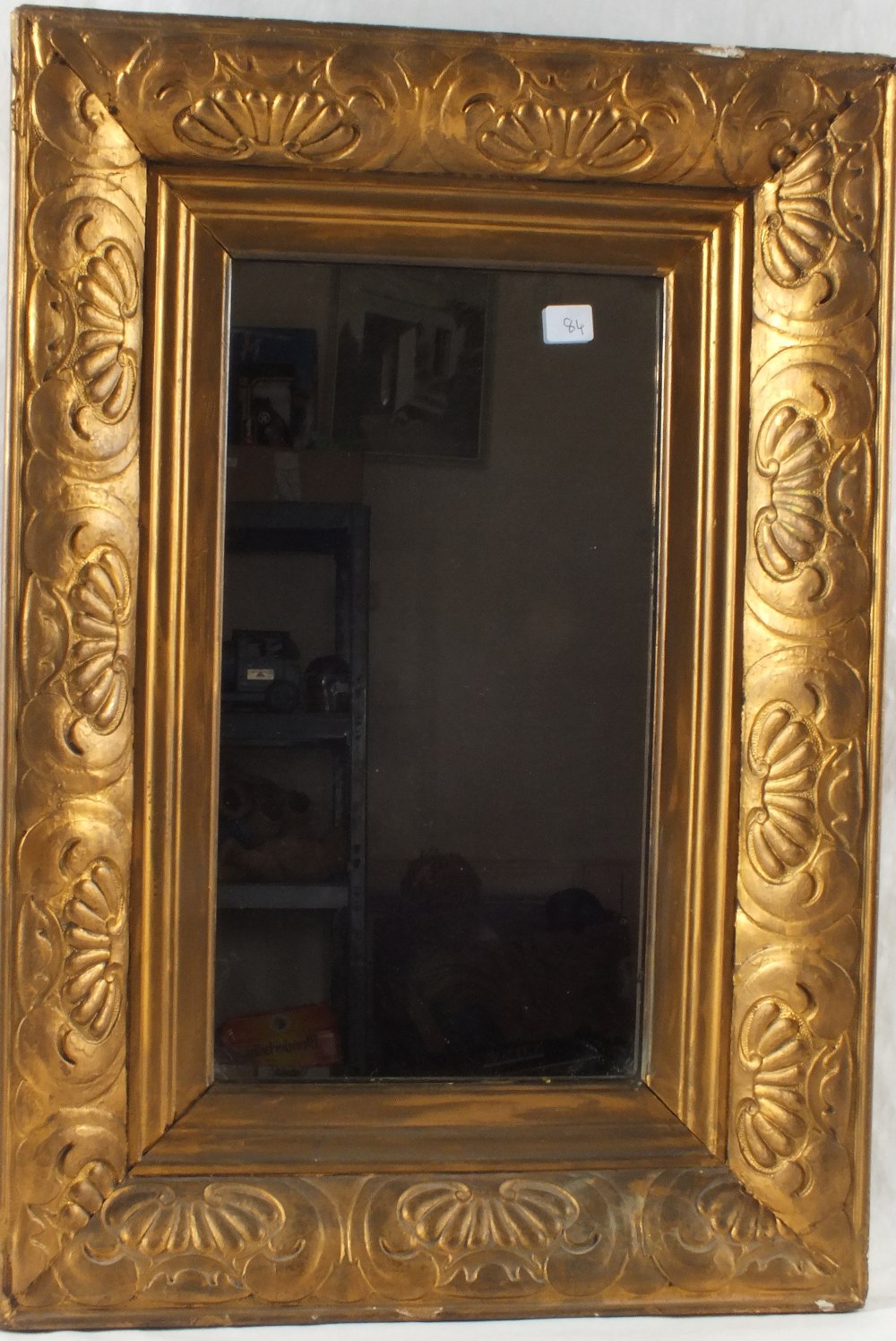 A gilt overmantel mirror and a wrought iron boot jack and one other mirror