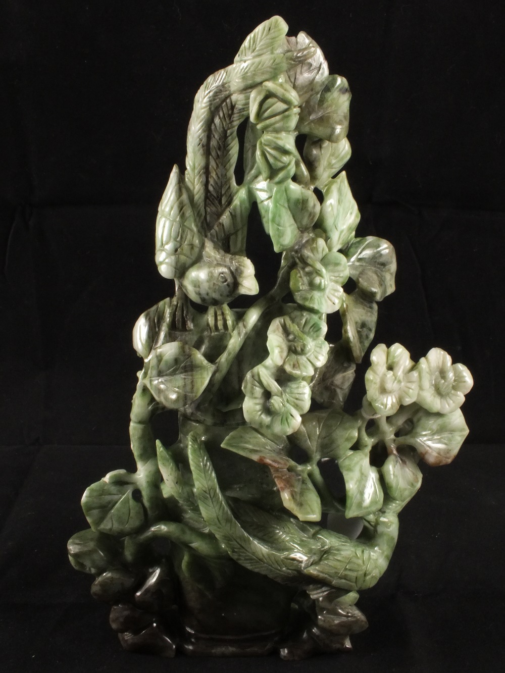 A Chinese carved spinach green Jade vase and cover formed as birds amongst foliage, height 9"