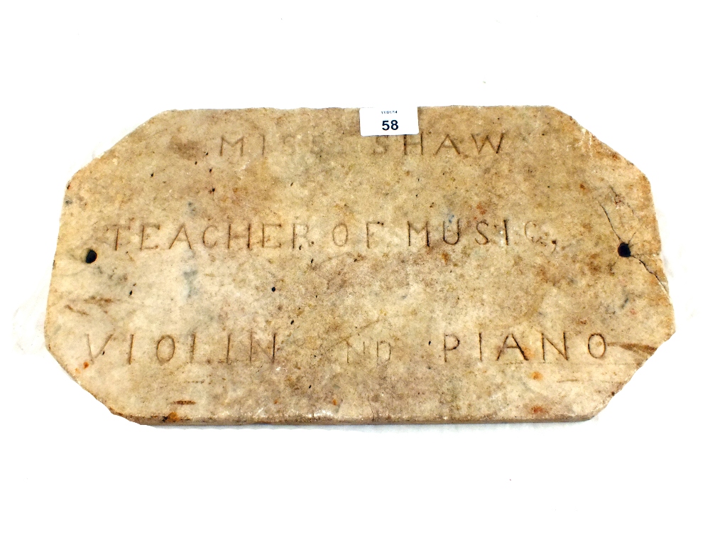 A marble name plaque incised "Miss Shaw, Teacher of Music, Violin and Piano"