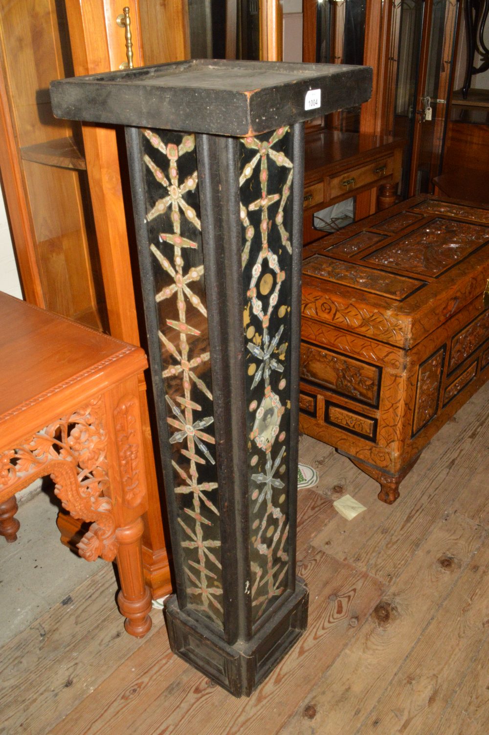 A Victorian ebonised plant stand featuring cigar labels