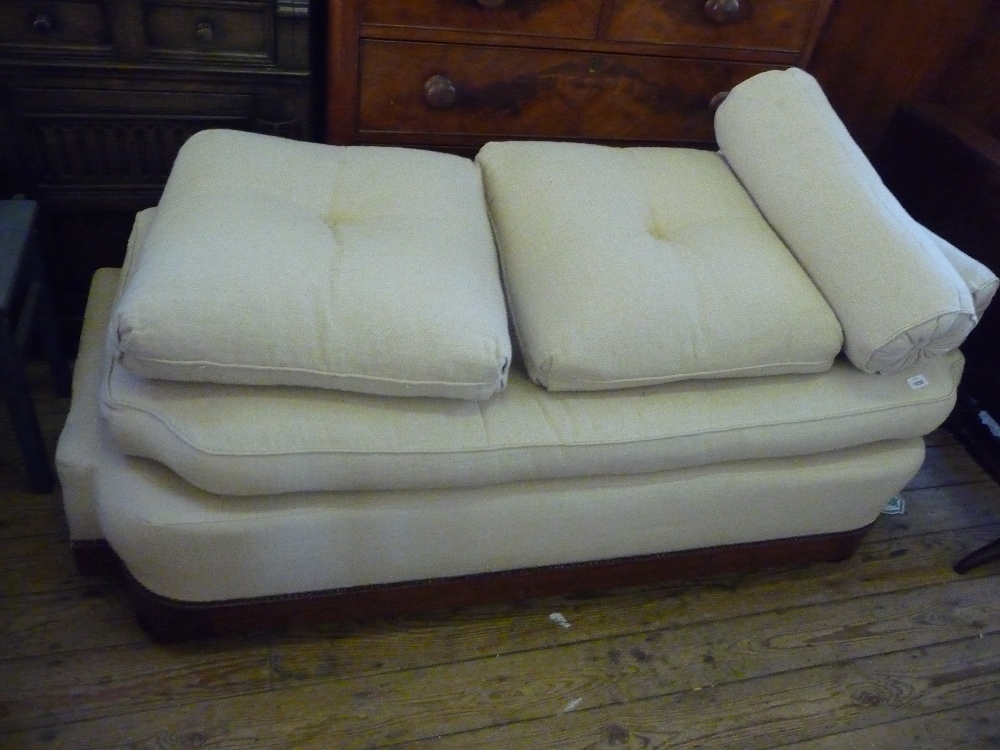 A cream upholstered day bed