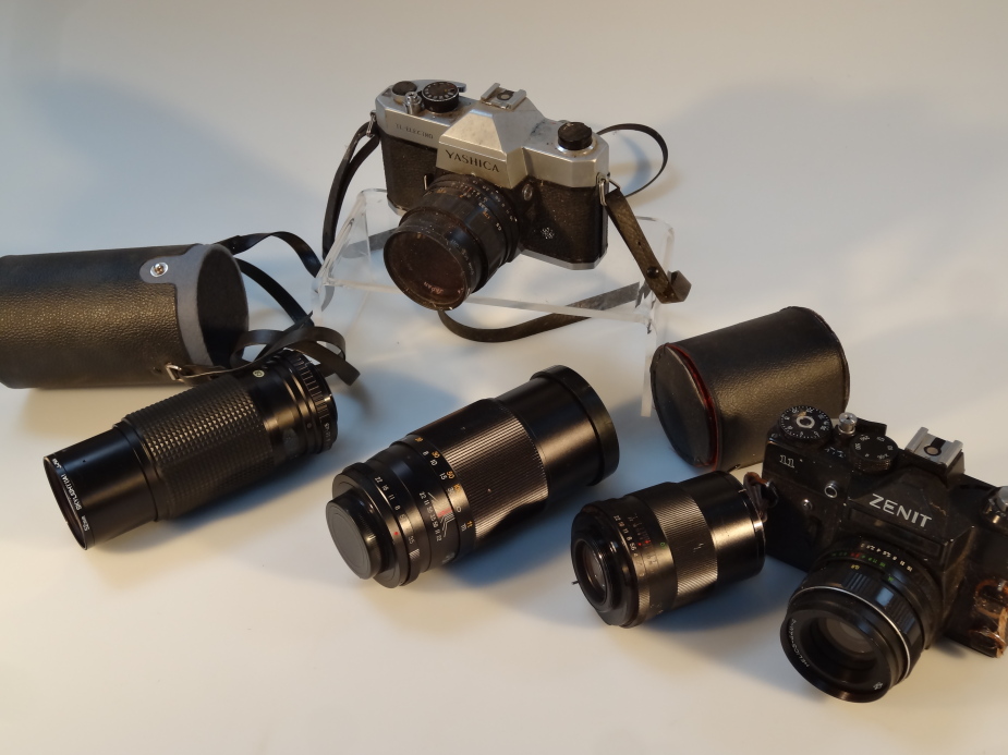 A quantity of cameras and lenses, to include a Zenit 11 with 2/58 lens, a Photax-Paragon 1:3.5 f=