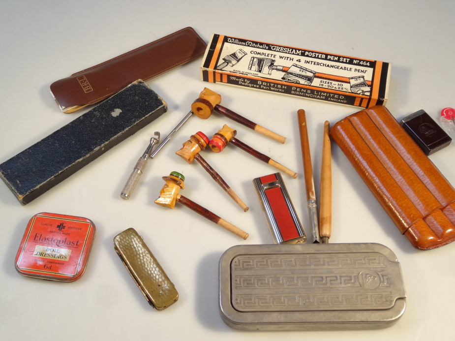 A quantity of smoking and cigar related bygones, to include a three sectional leather cigar case,