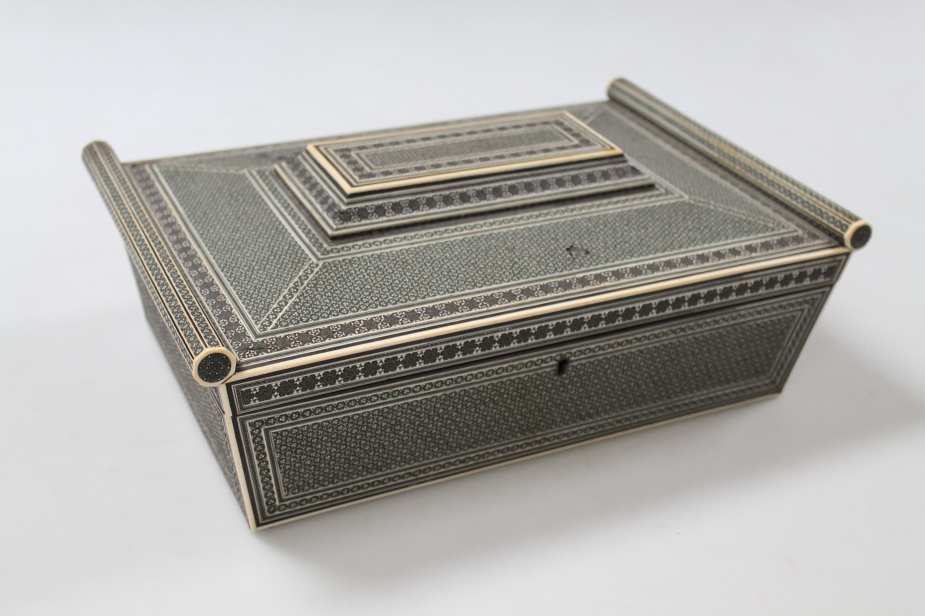 A mid 19thC Anglo Indian sadeli sandalwood sewing box, of sarcophagus form, the hinged lid revealing