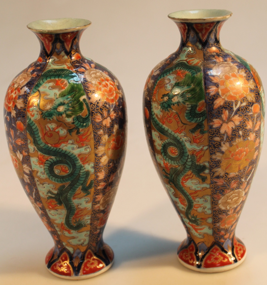 A pair of 19thC Imari vases, each of shouldered form, decorated with dragons and flowers in a