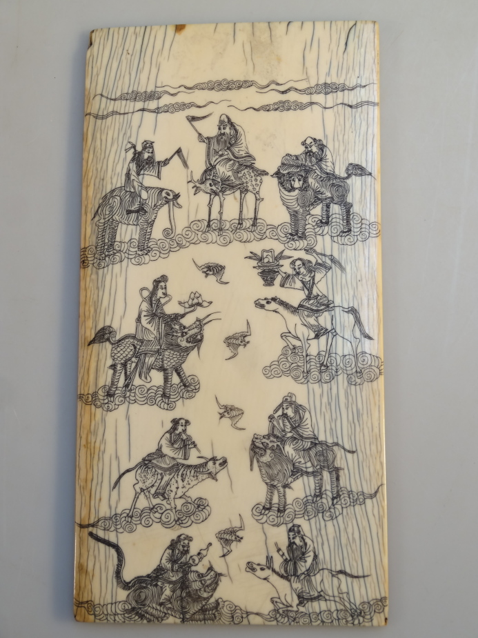 A Meiji period Japanese ivory panel, depicting various figures riding on animal backs interlaced