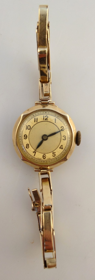 A ladies wristwatch, with an expanding bracelet, and oval dial, yellow metal, stamped 9c, 20.2g