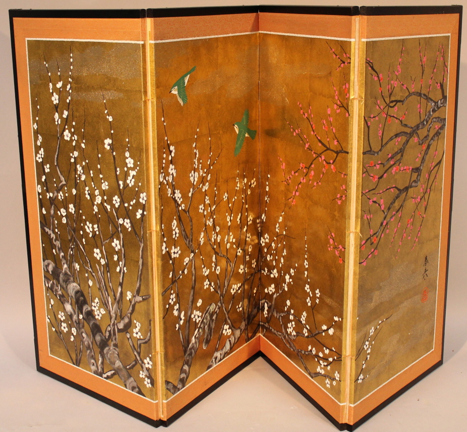 A Japanese lacquer screen, of four fold form, handpainted with foliage on a gilt ground, after a