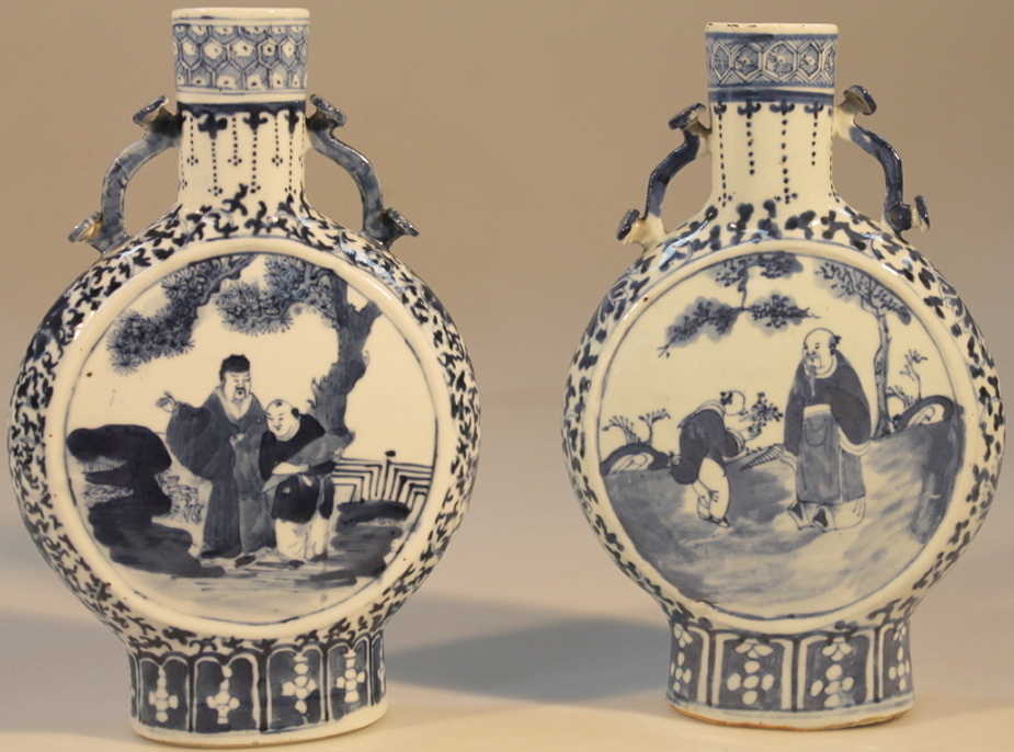 A pair of Chinese moon flasks, of typical form with heart headed handles decorated in underglaze