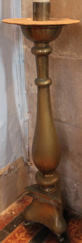 An early 20thC brass free standing candle sconce, of circular form, with a baluster column, raised