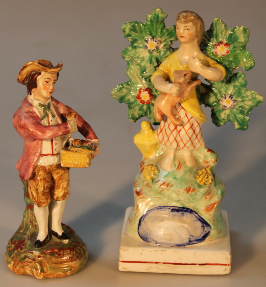 An early 19thC Staffordshire figure, by John Walton, of a girl holding a lamb before a bocage, on