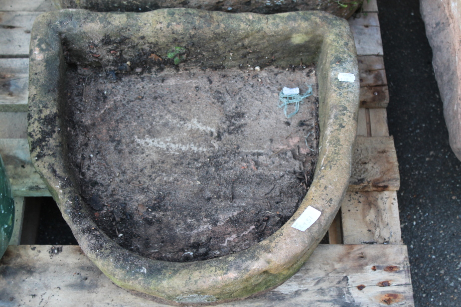 A stone trough, of D end form, 37cm wide, 42cm deep, 16cm high.