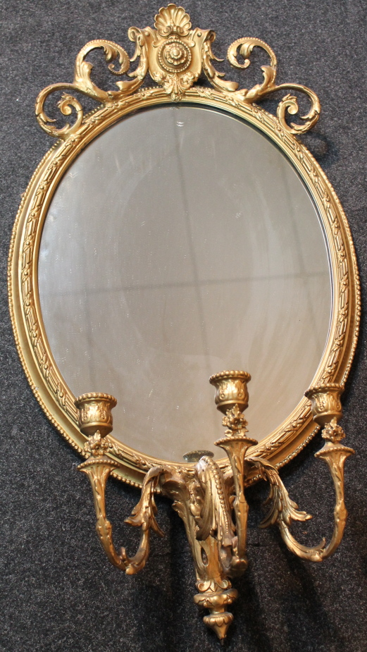 An Empire style giltwood girandole, probably third quarter 20thC, of oval form, centred by a