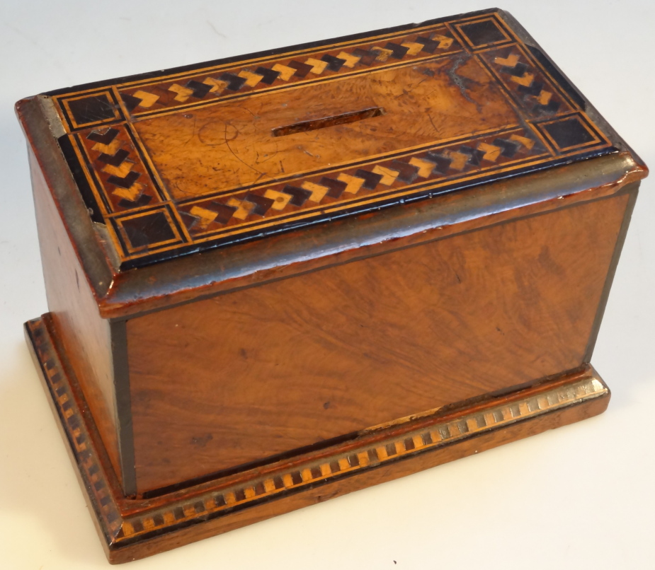 A 19thC walnut money box, of rectangular form, with a Tunbridge style outline to the top and base,