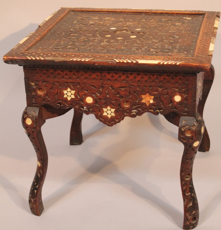 An early 20thC Chinese hardwood jardiniere stand, the square top heavily carved with a bone border