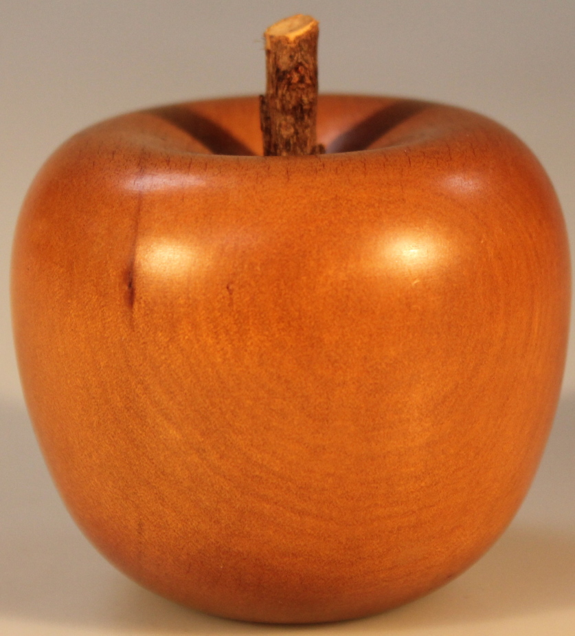 A turned Kauri wood apple, North Island, New Zealand, 9cm high.