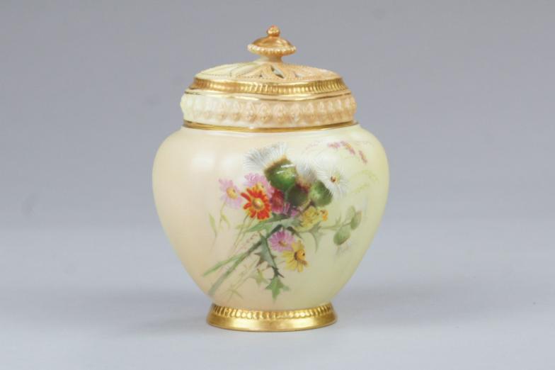 A Royal Worcester blush ivory urn shaped pot pourri vase and cover, painted with thistles and