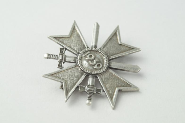 A Third Reich War Merit Cross, with swords, having pin back mounting.