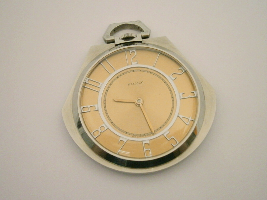 A Rolex pocket watch, in polished steel case with bronze coloured dial and visible jewelled movement