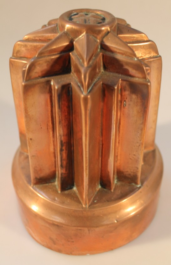 A Victorian copper geometric pattern jelly mould, 17cm high.