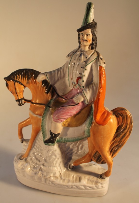 A 19thC Staffordshire pottery figure group of a horseman, 32cm high.