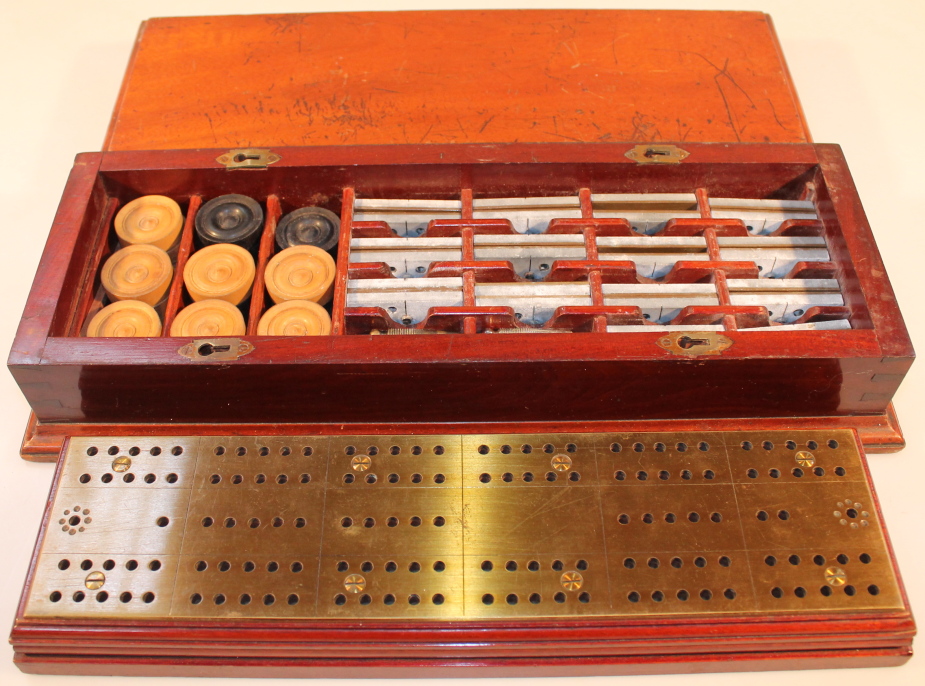 An early 20thC games compendium, in a fitted mahogany case, with brass cribbage board and