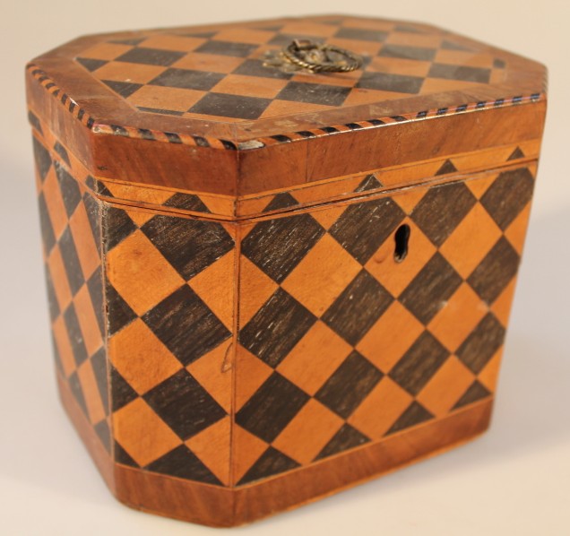 A 19thC parquetry octagonal tea caddy of chequerboard design, the cover crossbanded bordered by