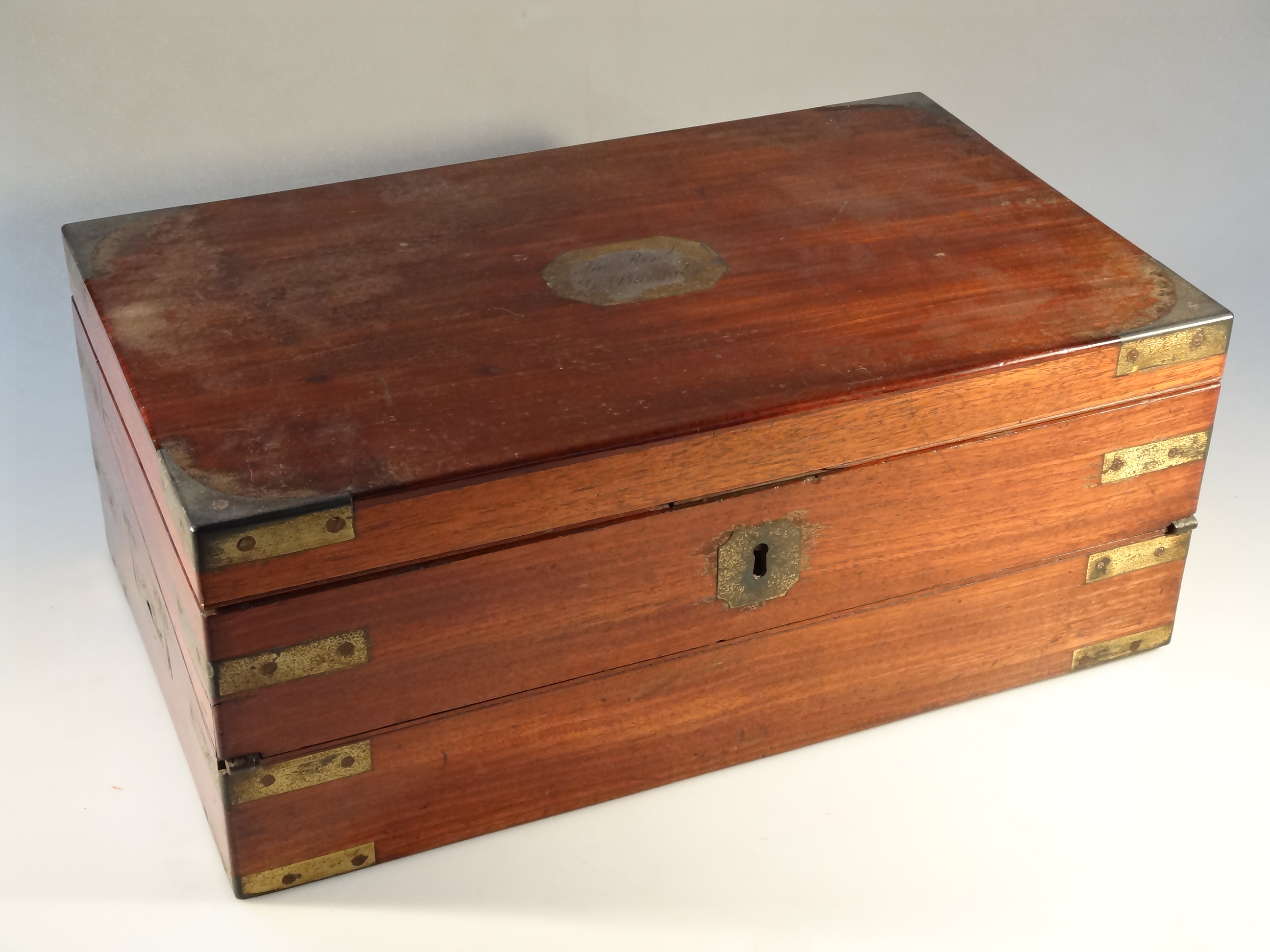 A 19thC mahogany travelling writing slope, the lid with brass cartouche engraved the Reverend G.