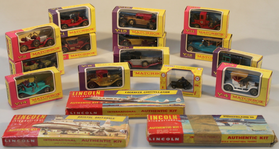 A collection of Matchbox die-cast model vehicles, and three Lincoln International model kits of