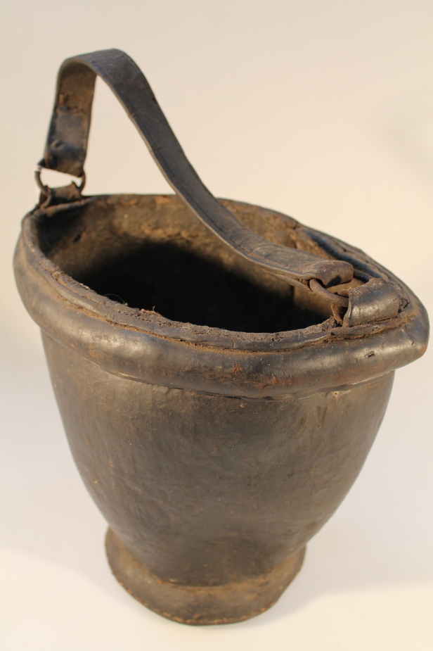 A 19thC leather powder bucket, 28.5cm high 32cm wide.