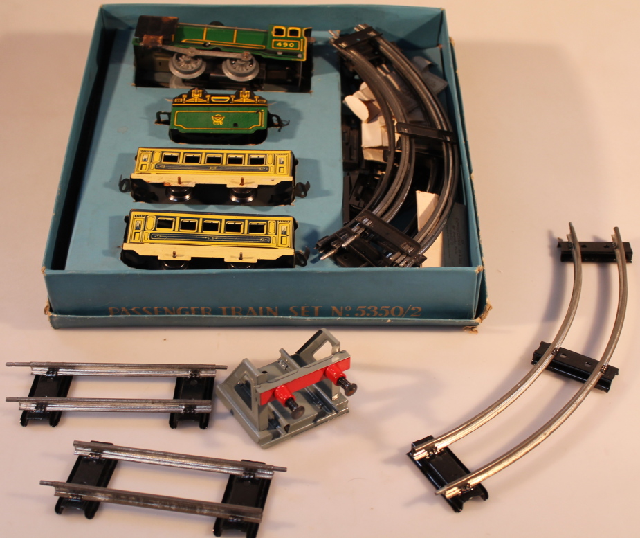 A tin plate clock-work passenger train set and Hornby 0 gauge accessories, to include buffer stop,