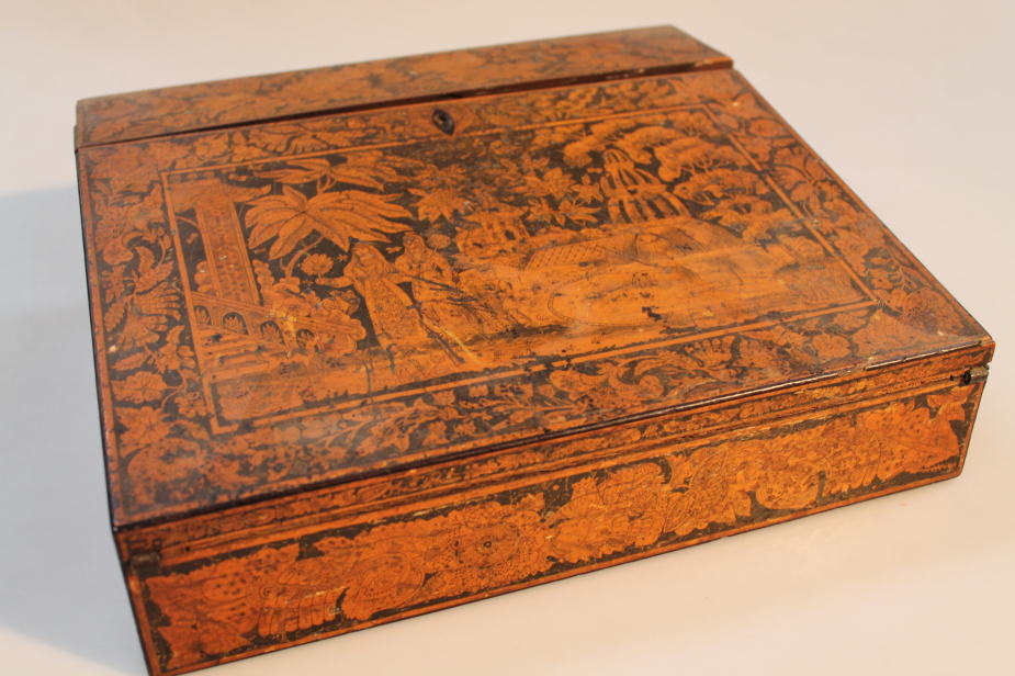 A Regency penwork portable writing desk, the sloping top and sides decorated with Indian figures