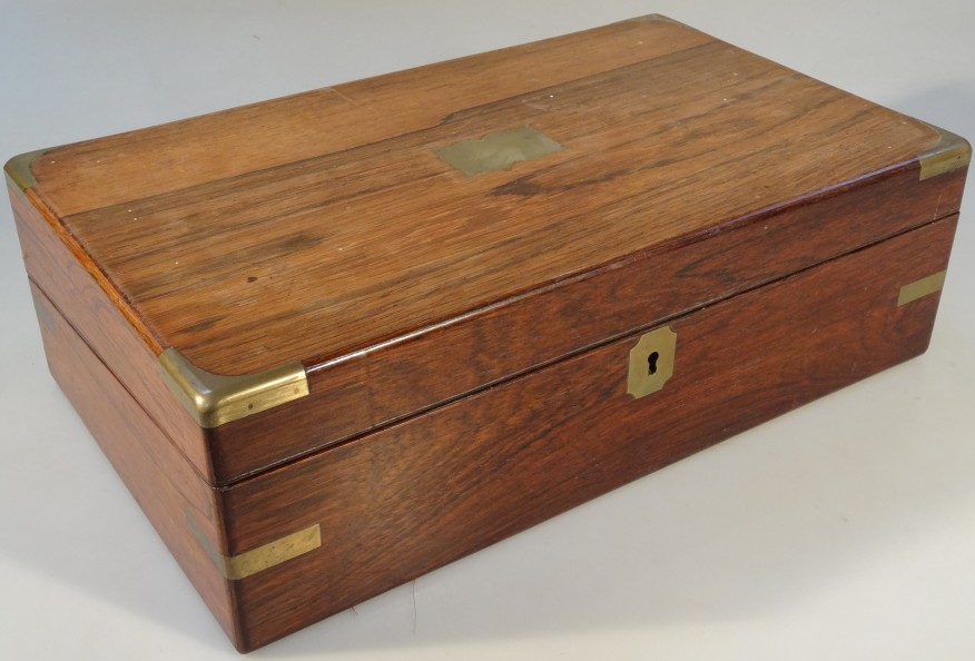 A 19thC rosewood writing box, with brass mounts internally fitted with later velvet slope and two
