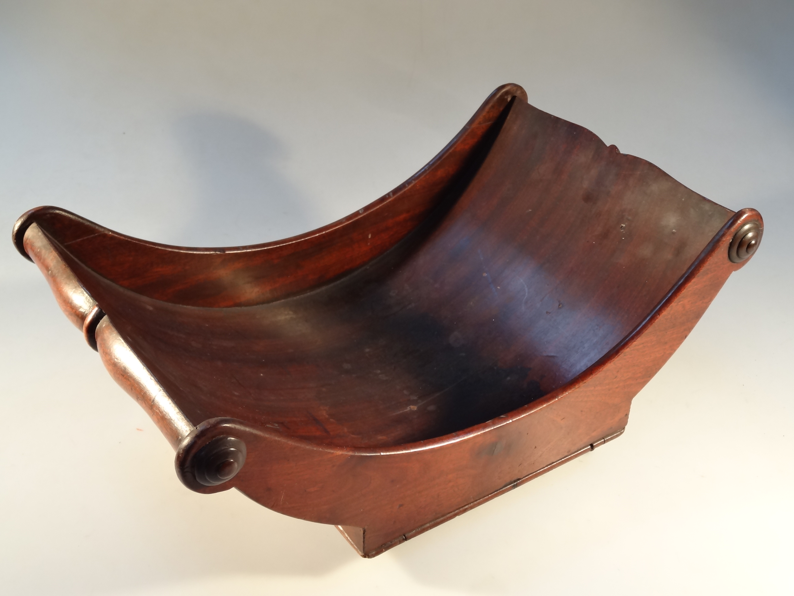 A 19thC mahogany cheese coaster, on miniature casters, 41cm long.