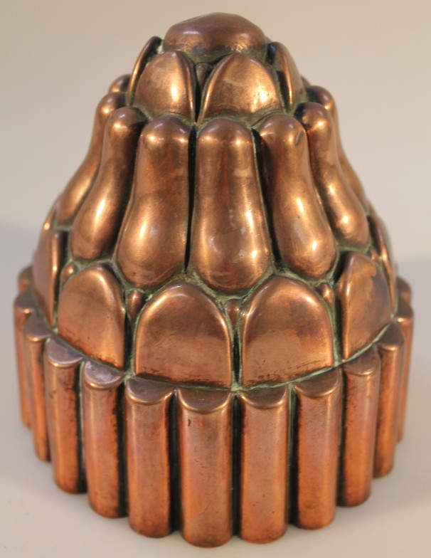 A Victorian copper circular jelly mould, 12cm diameter.