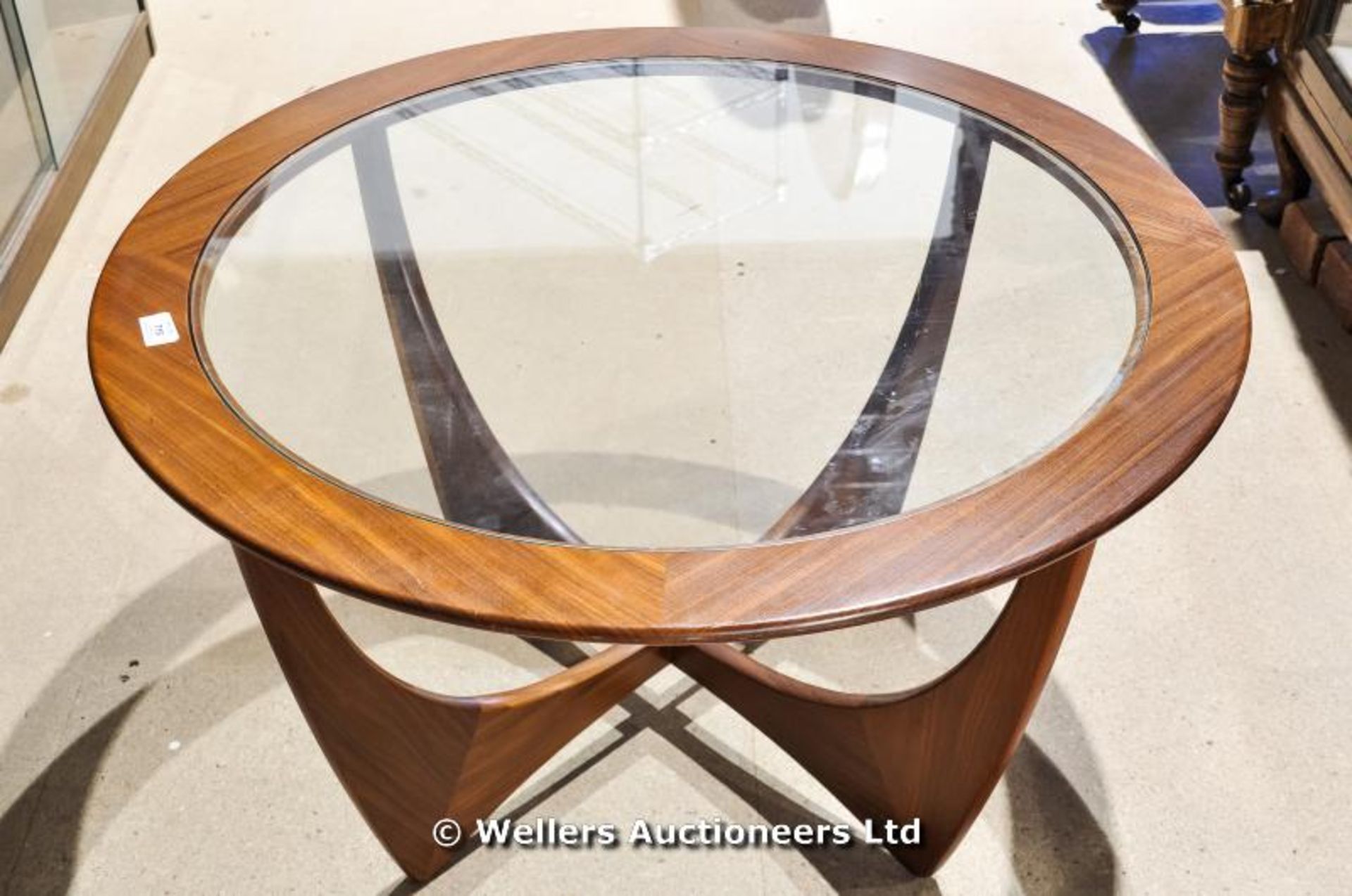 A G Plan circular glass and teak coffee table with X frame supports