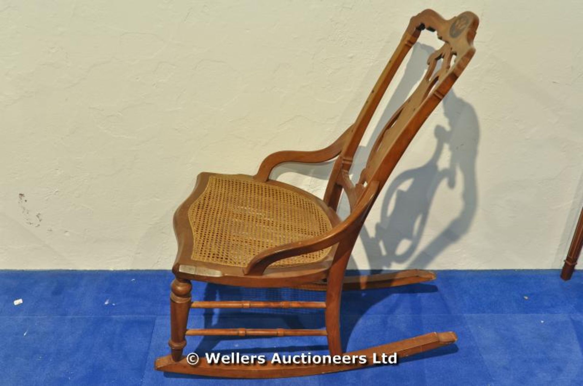 A rocking nursing chair with bergère cane seat inlaid detail to cresting rail and pierced lyre