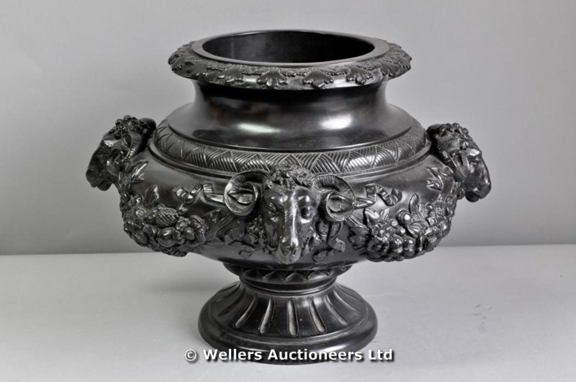 A bronze pedestal planter with rams had detail with swags