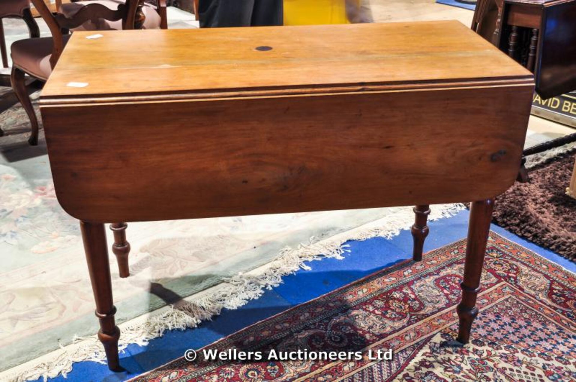 A Victorian Pembroke table on turned legs