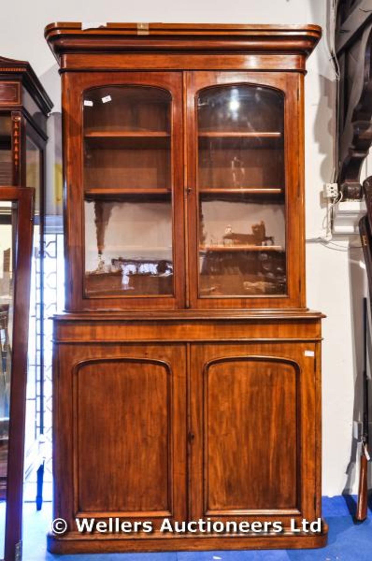 A Victorian bookcase over double cupboard, glass arched doors to bookcase, 225cm high max width,