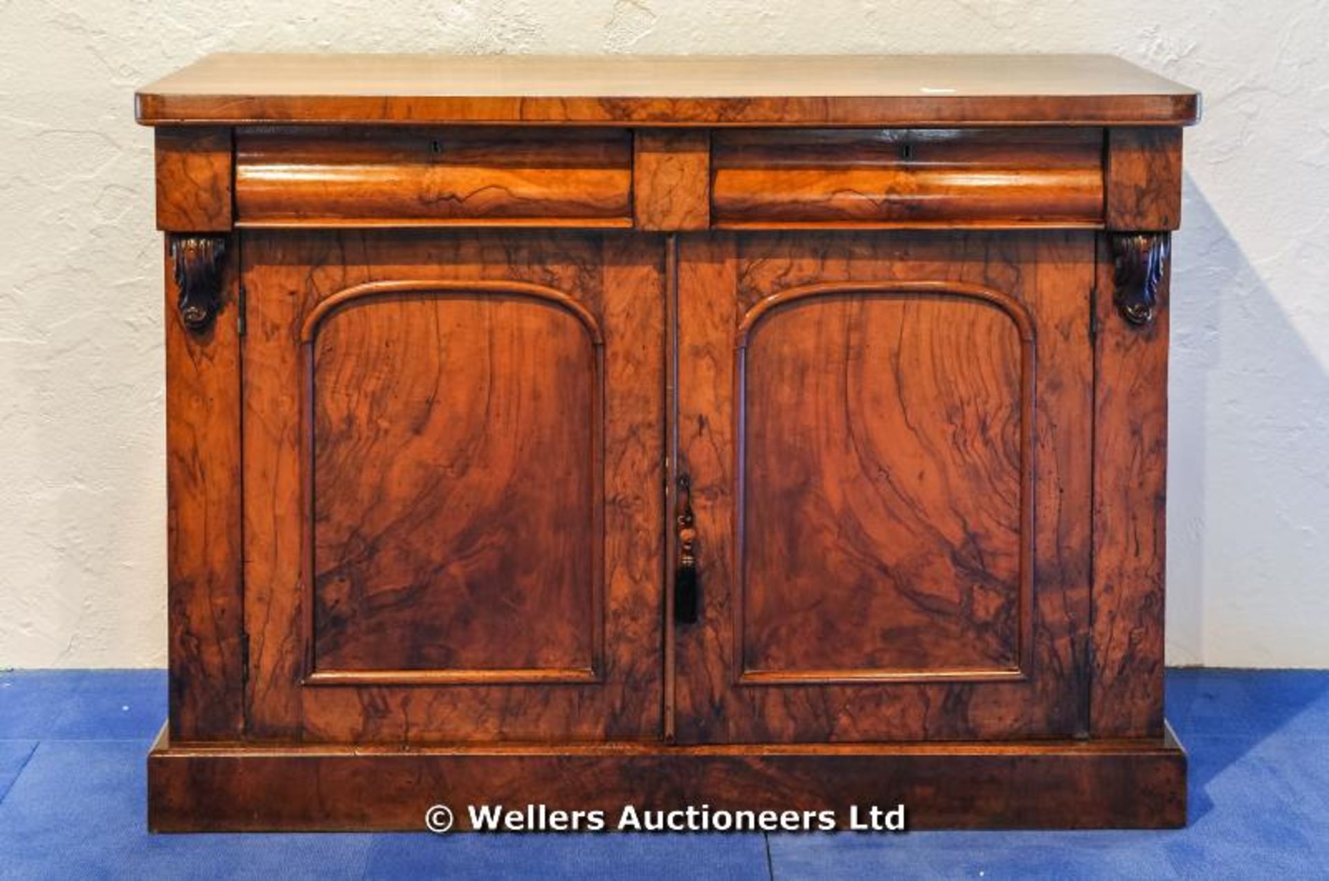 A walnut chiffonier with two frieze drawers over two cupboard doors